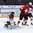 ZUG, SWITZERLAND - APRIL 20: Latvia's Denijs Romanovskis #1 makes the save while Switzerland's Calvin Thurkauf #18 looks on during preliminary round action at the 2015 IIHF Ice Hockey U18 World Championship. (Photo by Francois Laplante/HHOF-IIHF Images)